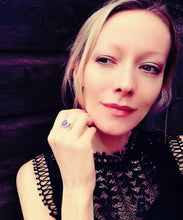 Load image into Gallery viewer, a model wearing a sterling silver oval mood ring with a purple color meaning