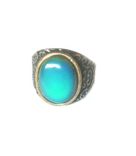 Load image into Gallery viewer, a bronze mood ring turning green blue color