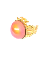 Load image into Gallery viewer, a mood ring with a circular mood turning an orange color and a gold brass band
