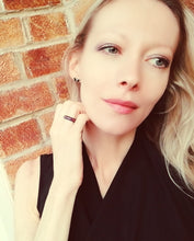 Load image into Gallery viewer, blonde model wearing a mood ring that is magnetic with a swirl pattern