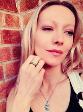 Load image into Gallery viewer, model wearing a magnetic mood ring with swirl marble pattern and swirl mood necklace