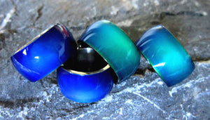 wider stainless steel band mood rings showing a blue and green color