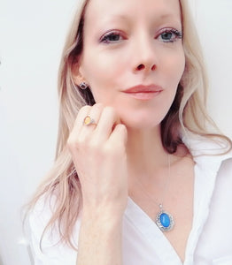 blonde model in white shirt wearing celtic silver mood ring and a silver mood locket necklace
