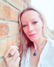 Load image into Gallery viewer, model wearing a bronze mood pendant necklace and a mood ring in bronze color