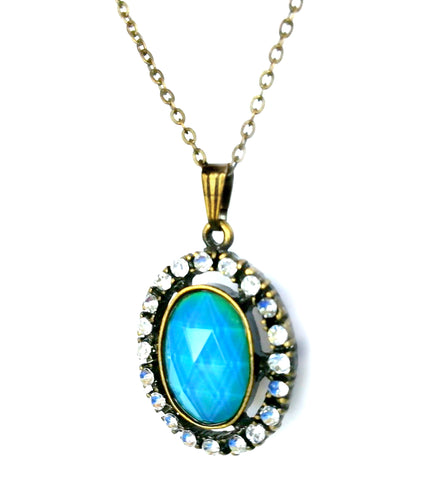 an oval mood pendant necklace with blue mood color and stones around the edges