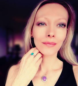 a beautiful blonde model wearing a sterling silver mood ring and a sterling silver mood pendant locket by best mood rings