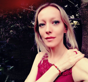 blonde model wearing a red agate mood ring and bracelet