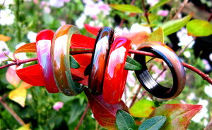 black, red, green agate mood rings in the garden