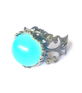 bronze mood ring with adjustable band showing a blue green mood meaning color