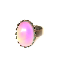 Load image into Gallery viewer, a bronze mood ring with crown setting showing a pink color mood meaning