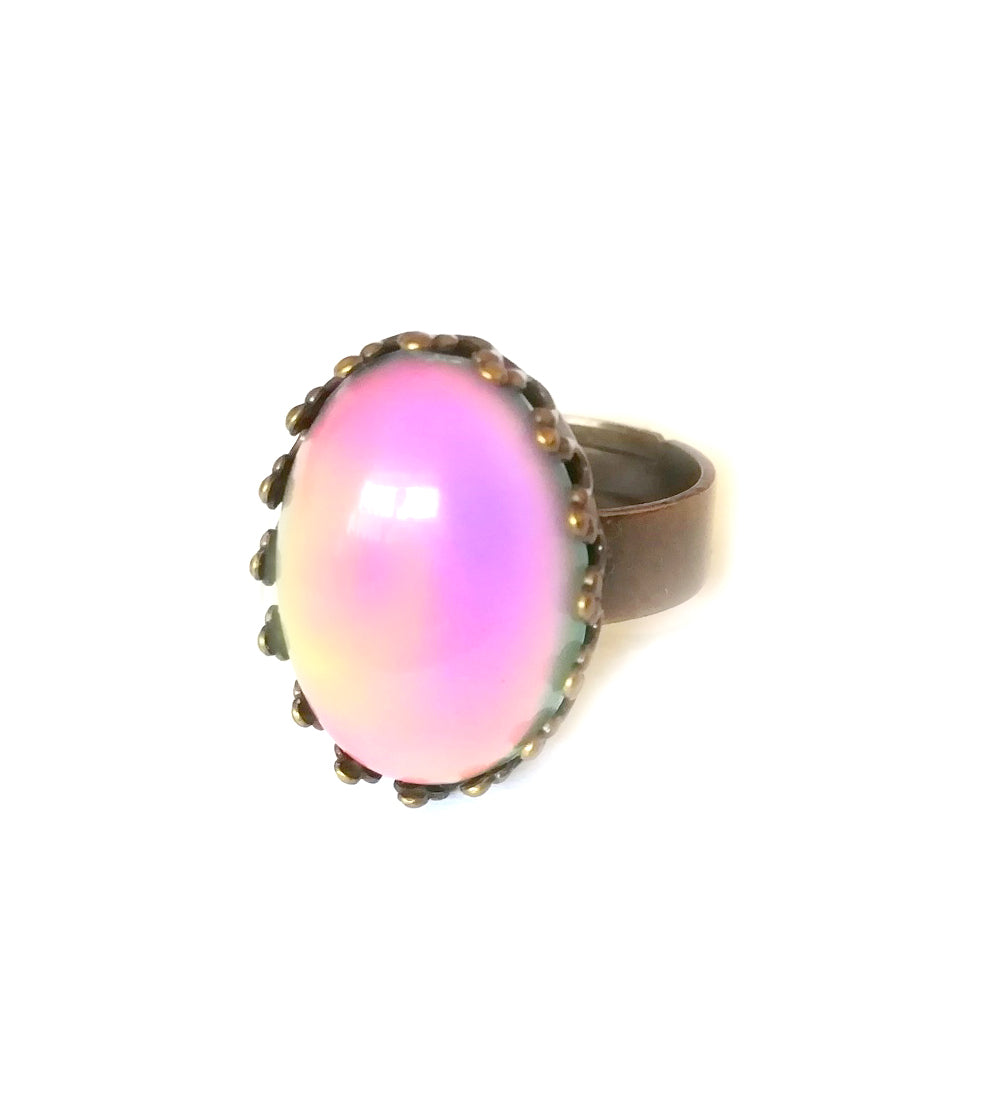 a bronze mood ring with crown setting showing a pink color mood meaning