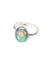 Load image into Gallery viewer, a child sized oval mood ring with flower inside