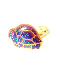 a turtle mood ring in a golden color for children