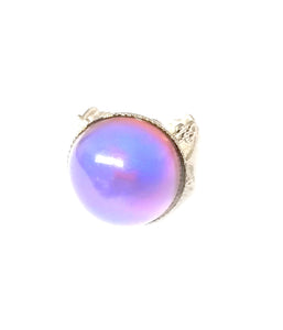 a circular mood ring showing a purple pink color mood by best mood rings