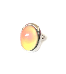 a mood ring with oval design turning a yellow orange color