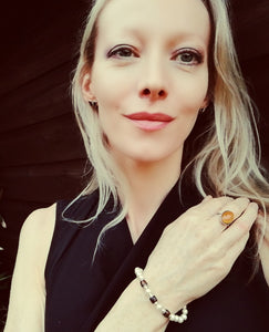 blonde model wearing an oval mood ring and a mood bracelet