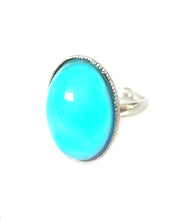 Load image into Gallery viewer, an adjustable mood ring with a turquoise color