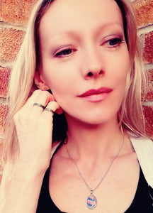 model wearing band mood rings and a oval mood pendant necklace