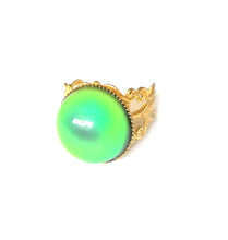 Load image into Gallery viewer, a circular shaped mood ring with gold shade band in brass