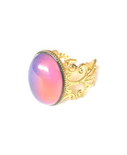 Load image into Gallery viewer, a golden band mood ring turning a pink happy mood