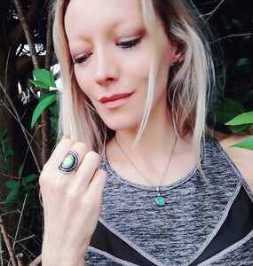 model looking at a mood ring in the garden