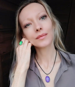 model wearing an oval mood necklace with black cord and an adjustable mood ring