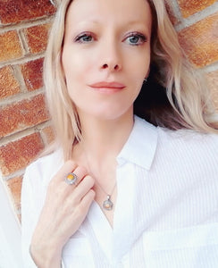 model wearing mood necklace and mood ring in a white shirt