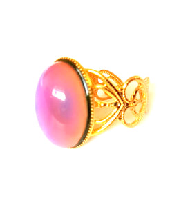 mood ring with a gold band with a pink mood