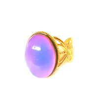 Load image into Gallery viewer, a mood ring turning purple set on a golden shade adjustable band