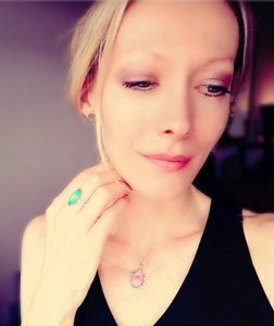 a beautiful model wearing a silver mood ring and silver mood necklace by best mood rings