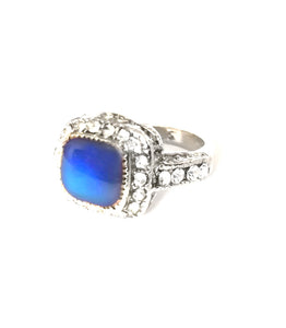 a mood ring with a blue mood with a silver shade band