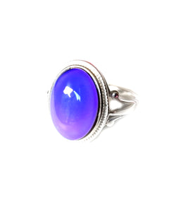 a sterling silver mood ring with a purple mood color
