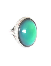Load image into Gallery viewer, sterling silver mood ring with an oval mood showing a beautiful green color mood meaning