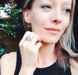 blonde model wearing a vintage mood ring and mood earrings
